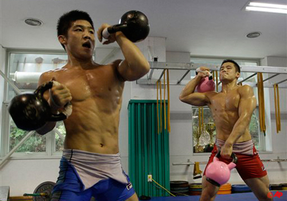 South Korean wrestler Kim Hyun woo, left, trains in preparation for the upcoming London Olympics at the National Training Center in Seoul, South Korea, Wednesday, July 4, 2012. (AP Photo/Lee Jin man)