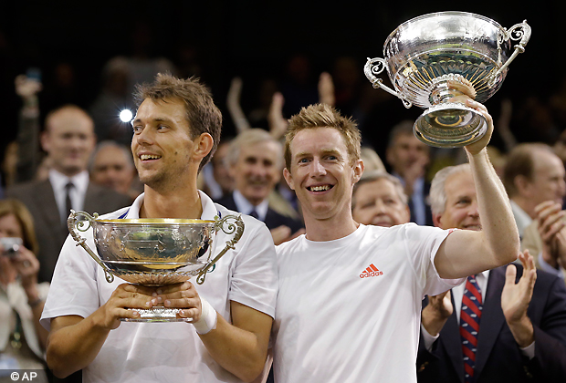 Frederik Nielsen of Denmark, left, and Jonathan Marray of Britain hold the trophies after defeating Robert Lindstedt of Sweden and Horia Tecau of Romania in the men's doubles final match at the All England Lawn Tennis Championships at Wimbledon, England, Saturday, July 7, 2012. (AP Photo/Kirsty Wigglesworth)