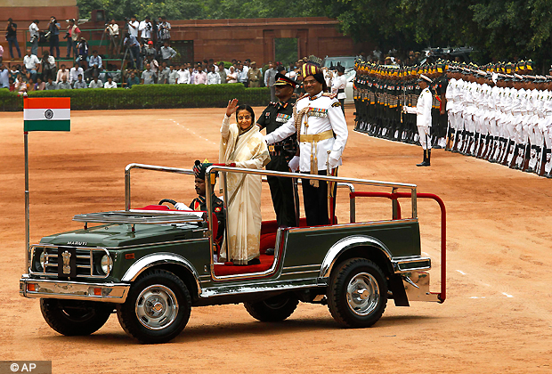 Former Indian President Pratibha Patil waves after inspecting a guard of honor at the Presidential Palace, in New Delhi, Wednesday, July 25, 2012. New President Pranab Mukherjee, 76, pledged to fight widespread poverty and work to alleviate hunger as he was sworn in Wednesday as India's 13th president in an elaborate ceremony in Parliament. (AP Photo)