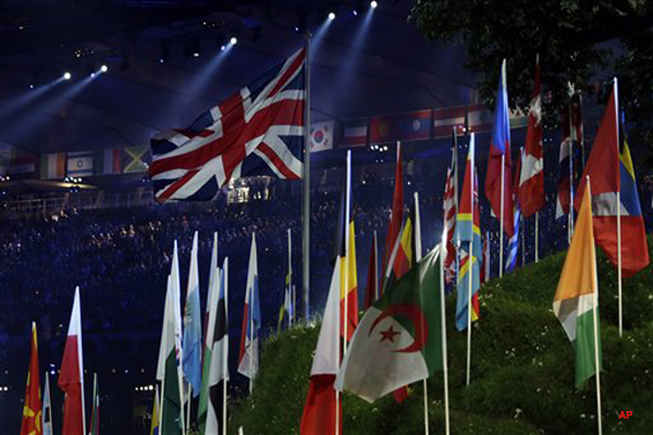 The British flag flies among those of other countries participating in the 2012 Summer Olympics during the Opening Ceremony, Saturday, July 28, 2012, in London. (AP Photo/Mike Groll)