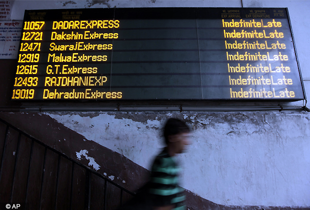 A commuter walks past the status board for trains displaying Indefinite Late for all the trains following the power outage that struck in the early hours of Monday, July 30, 2012, at a train station in New Delhi. Northern India was plunged into darkness Monday after a supply grid tripped because of overloading, officials said. (AP Photo)