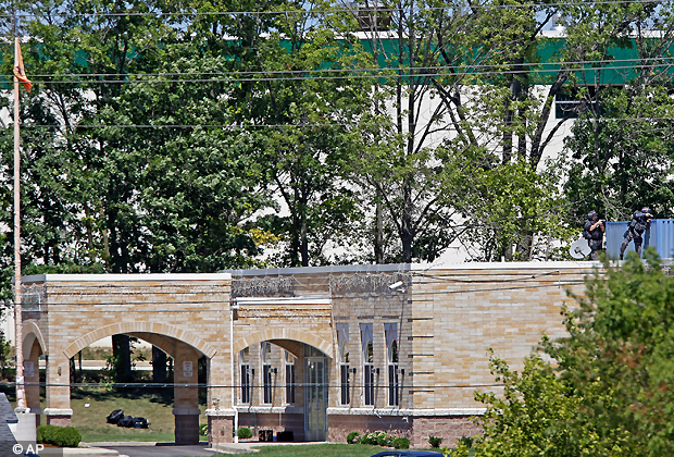 Police storm a Sikh temple in Oak Creek, Wis., Sunday, Aug. 5, 2012, after reports of a shooting, where police and witnesses describe a chaotic situation with an unknown number of victims, suspects and possible hostages. (AP Photo)