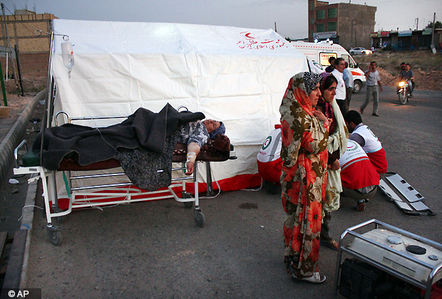 A woman lies injured on a stretcher in a street after an earthquake in the city of Varzaqan in northwestern Iran, on Saturday, Aug. 11, 2012. A 6.2 magnitude earthquake hit the towns of Ahar, Haris and Varzaqan in East Azerbaijan province in northwestern Iran on Saturday, state TV said. (AP Photo)