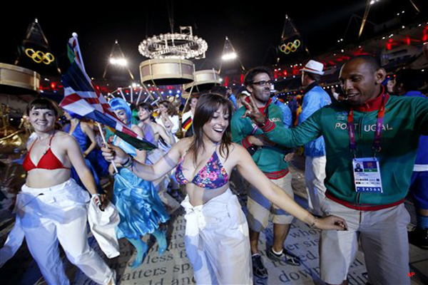 Portugal's Nuno Delgado, right, dances with performers during the Closing Ceremony at the 2012 Summer Olympics, Monday, Aug. 13, 2012, in London. (AP Photo/Jae C. Hong)