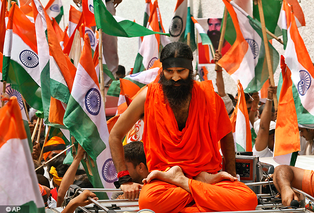 Indian yoga guru Baba Ramdev sits on a jeep as he along with his supporters march to India's Parliament to intensify an anti corruption protest and press for a change of government in New Delhi, India, Monday, Aug. 13, 2012.