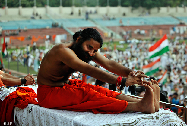 Indian yoga guru Baba Ramdev stretches during an anti corruption protest in New Delhi, India, Tuesday, Aug. 14, 2012. (AP Photo)
