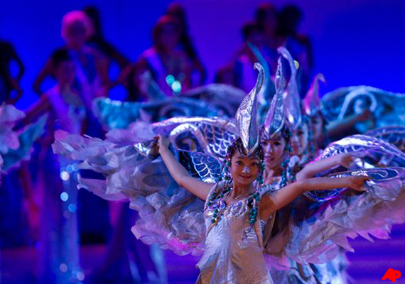 Chinese dancers performs in front of Miss World contestants on stage during the Miss World 2012 beauty pageant at the Ordos Stadium Arena in inner Mongolia, China Saturday, Aug. 18, 2012. (AP Photo/Andy Wong)