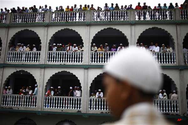 Nepalese Muslims greet each other after offering Eid al Ftr prayers at a mosque in Katmandu, Monday, Aug. 20, 2012. Muslims around the world are celebrating Eid al Fitr, marking the end of Ramadan, the Muslim calendar's ninth and holiest month during which followers are required to abstain from food and drink from dawn to dusk. (AP Photo/Niranjan Shrestha)