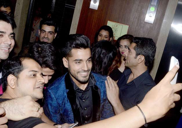 Gautam Gulati cheerfully poses with his fans for a selfie.