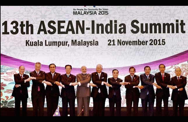 Prime Minister Narendra Modi join hands with other leaders during a group photo at the 13th ASEAN India Summit in Kuala Lumpur, Malaysia on Saturday. (PTI Photo)