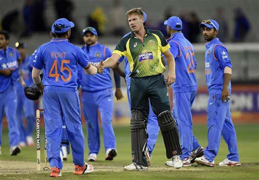 Australia's James Faulkner, center, shakes hands with Indian players after hitting the winning run during their One Day International cricket match in Melbourne, Australia, Sunday, Jan. 18, 2015. (AP Photo)