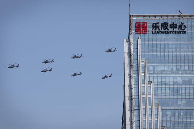Chinese Z 19 military helicopters fly in formation during a parade commemorating the 70th anniversary of Japan's surrender during World War II in Beijing.