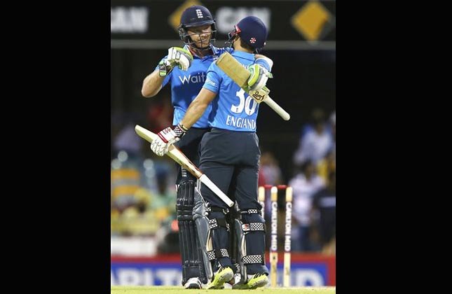 England's Ian Bell, left, and James Taylor, right, celebrate after England won the one day International cricket match against India in Brisbane, Australia, Tuesday, Jan. 20, 2015. (AP Photo)