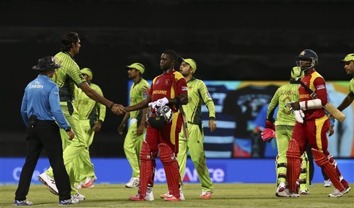 Pakistan's Mohammad Irfan, left, shakes hands with Zimbabwean batsmen after Pakistan won in the Pool B Cricket World Cup match in Brisbane, Australia, Sunday, March 1, 2015.Mohammad Irfan used his height to full effect to take four wickets as Pakistan defended a low total against Zimbabwe to get its World Cup campaign back on track with a 20 run victory on Sunday. (AP Photo)