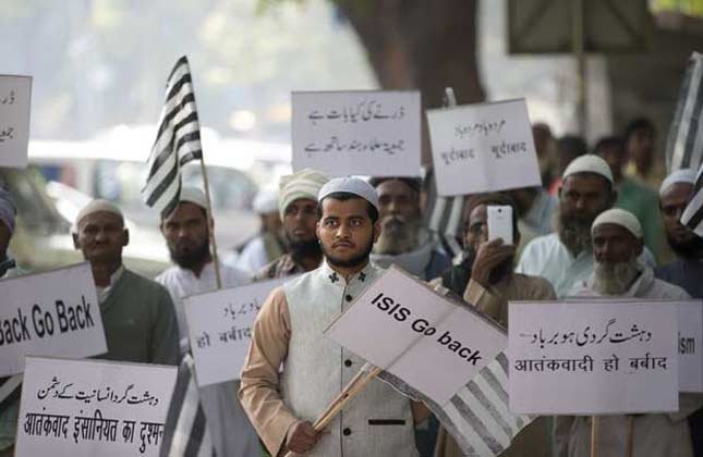 Indian Muslims hold banners and participate in a protest against ISIS, an Islamic State group, and Friday's Paris attacks, in New Delhi.