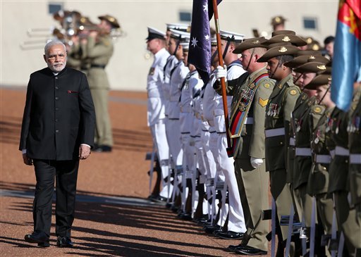 Indian PM Narendra Modi, left, inspects a honor guard during a ceremonial welcome in Canberra