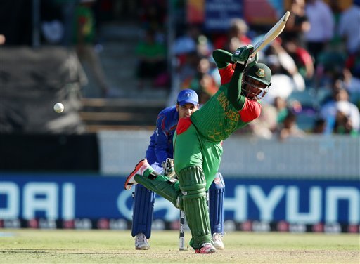 Bangladesh batsman Al Hasan Shakib watches his shot as Afghanistan's wicketkeeper Zazai Afsar looks on during their Cricket World Cup Pool A match in Canberra, Australia, Wednesday, Feb. 18, 2015. (AP Photo)